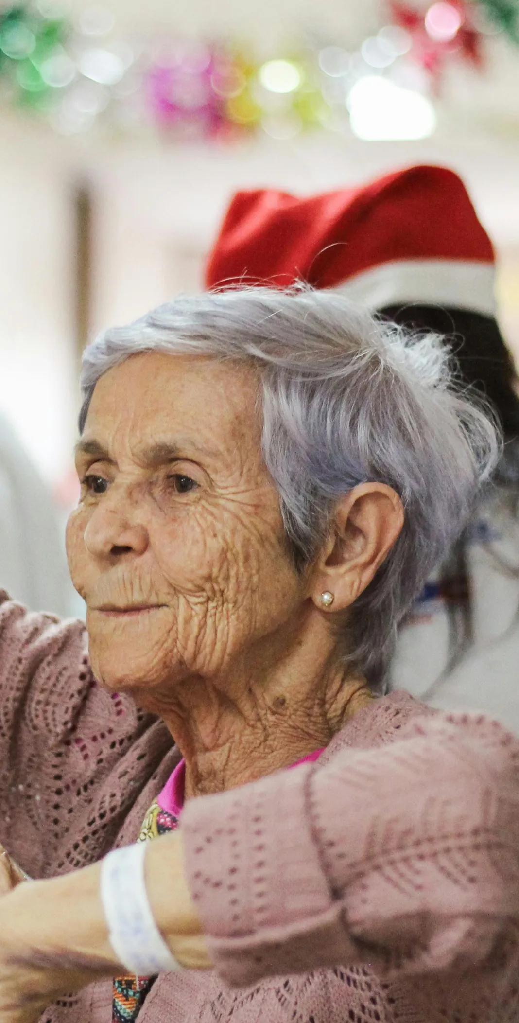 A senior lady enjoying Christmas celebrations.